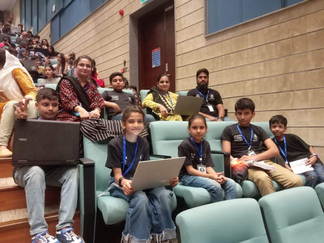 Sadiqa mentoring students at a STEM competition