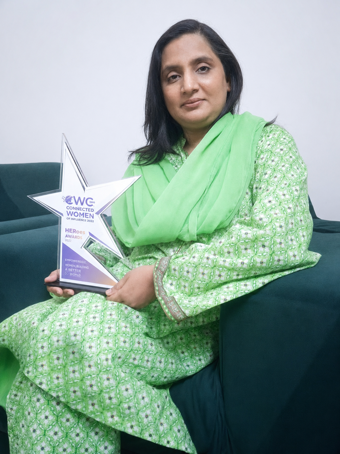 Sadiqa Akhter holding a women leadership award